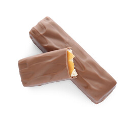 Pieces of chocolate bars with caramel on white background, top view