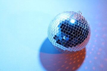 Bright shiny disco ball on color background. Space for text