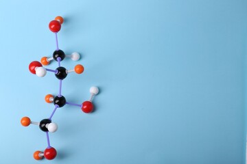 Molecule of sugar on light blue background, top view and space for text. Chemical model