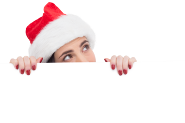 Pretty brunette in santa hat showing white poster