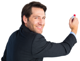 Businessman standing and writing while looking at camera