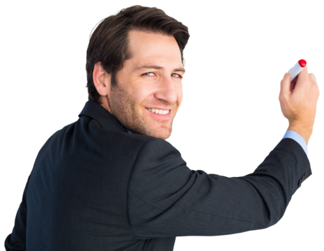 Businessman standing and writing while looking at camera