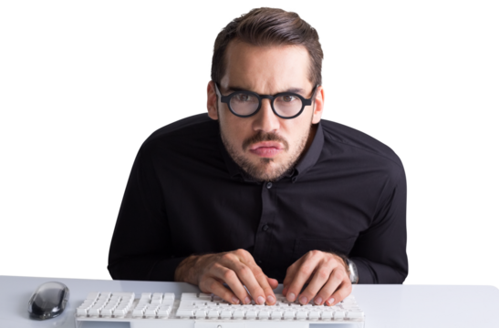 Concentrated businessman with glasses typing on keyboard