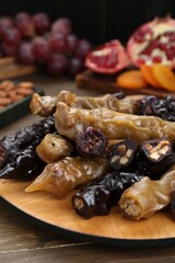 Many delicious sweet churchkhelas on wooden table, closeup