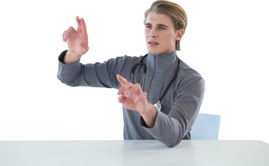 Male doctor touching imaginary interface screen while sitting at table