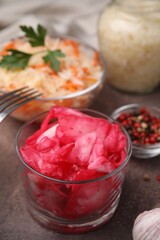 Delicious sauerkraut prepared according to different recipes on brown table, closeup view