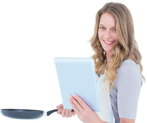 Smiling woman holding frying pan and tablet pc 