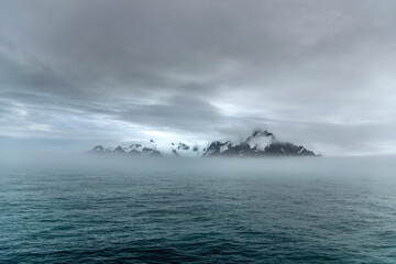 Icy Mountain Peaks of Elephant Island through the Antarctic Fog