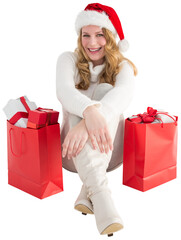 Smiling woman sitting on floor with shopping bag