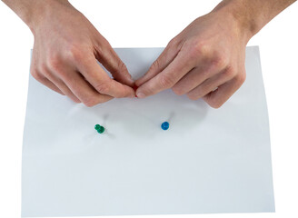 Man attaching push pin on paper
