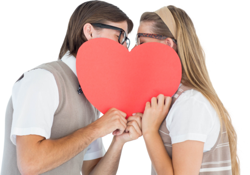 Geeky hipsters kissing behind heart card 