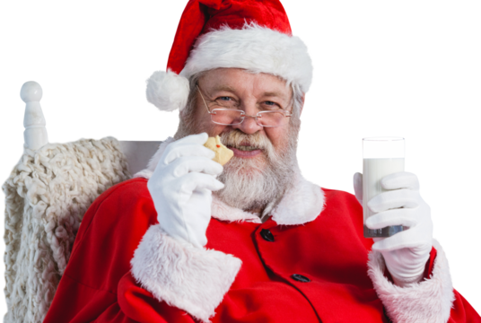 Santa Claus holding glass of milk and cookie