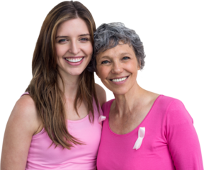 Smiling women in pink outfits posing for breast cancer awareness