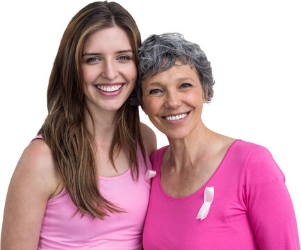 Smiling women in pink outfits posing for breast cancer awareness
