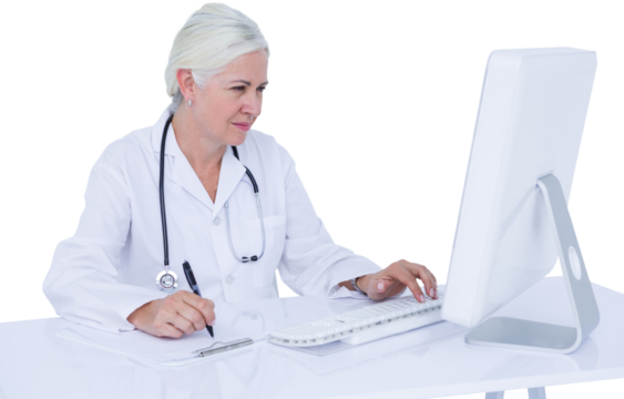 Female doctor using computer while writing on clipboard at desk