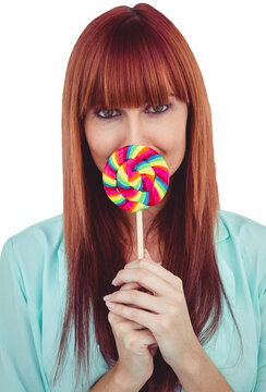 Smiling hipster woman with a lollipop