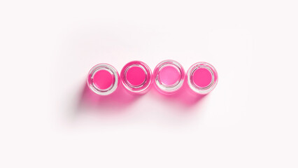 set of flasks, laboratory jars with pink liquid. On a white, light background. View from above.