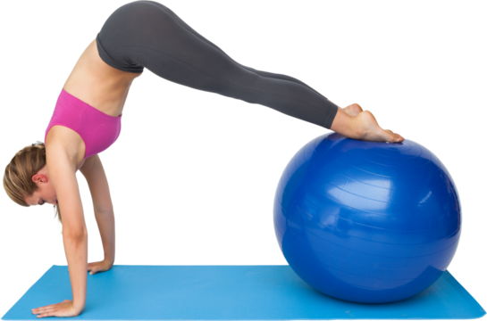 Side view of a fit woman stretching on fitness ball