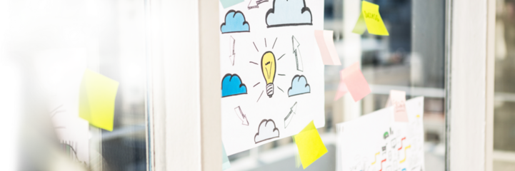 Charts and notes on glass wall in office