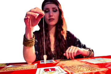 Female fortune teller holding pendulum with eyes closed 