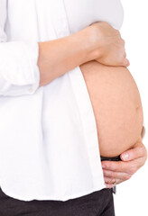 Midsection of pregnant woman holding belly