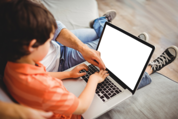 Father and son using computer together