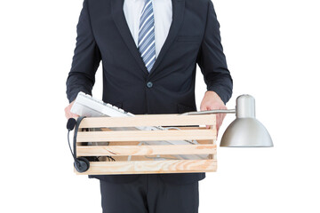Businessman holding box of his things - obrazy, fototapety, plakaty