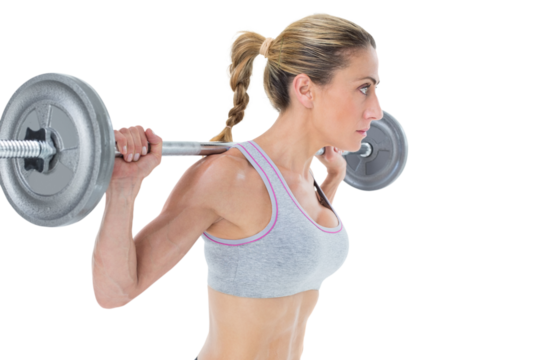 Strong female crossfitter lifting barbell behind head