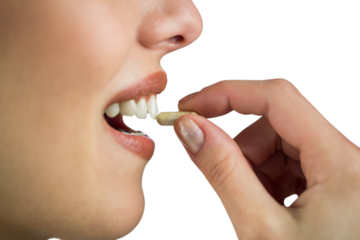 Woman taking pill on white background