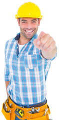 Portrait of smiling handyman pointing at you