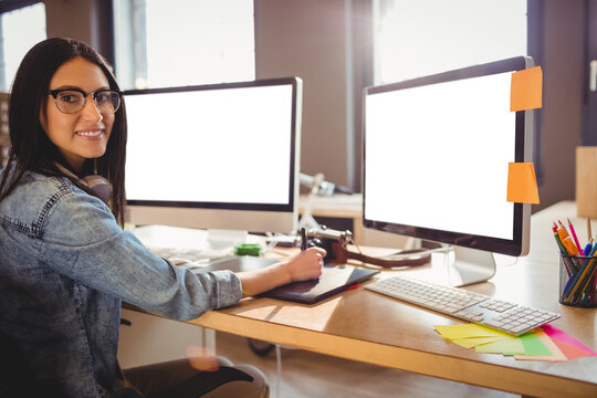 Businesswoman smiling while working at office