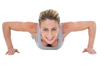 Strong woman doing press ups smiling at camera