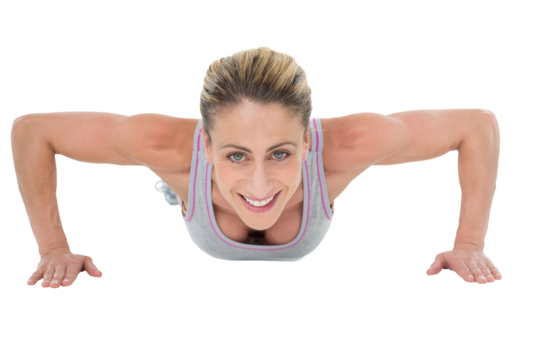 Strong woman doing press ups smiling at camera - Powered by Adobe