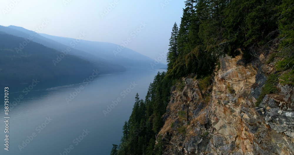 Sticker Idyllic view of tree mountain by river