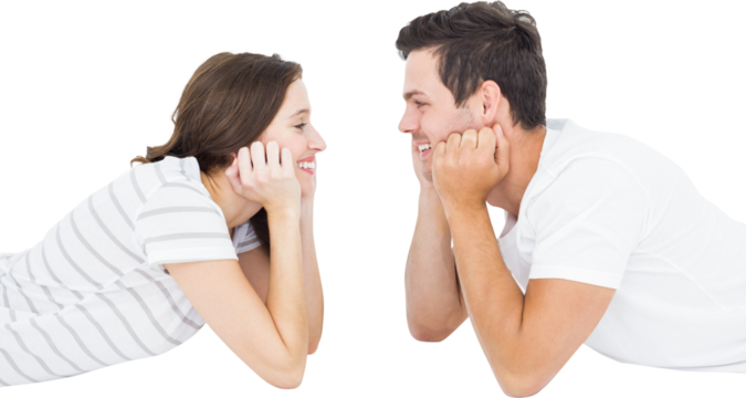 Happy couple lying on floor and looking at each other