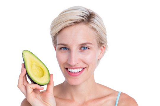 Pretty blonde holding half of an avocado