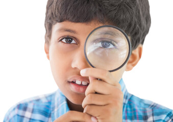 Fototapeta na wymiar Cute boy looking through a magnifying glass