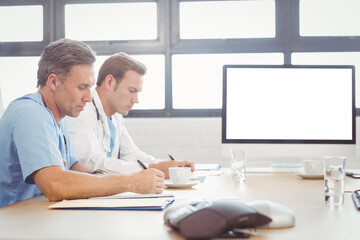 Fototapeta premium Doctors writing on paper