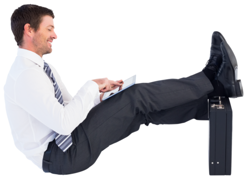 Businessman with feet up on briefcase
