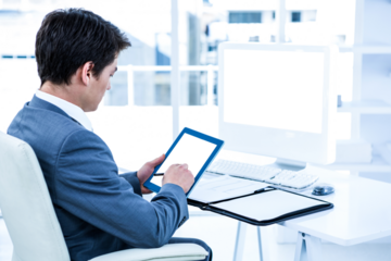 Businessman using digital tablet while sitting