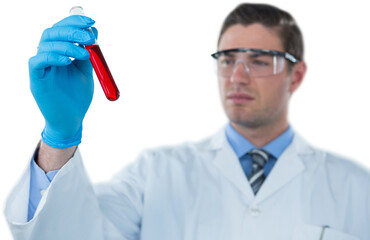 Doctor in protective glasses and surgical mask holding test tube