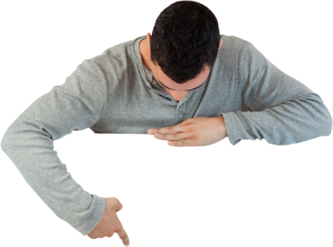 Young male looking and pointing at banner below him