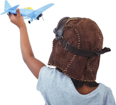 Rear view of girl holding toy airplane with arms raised