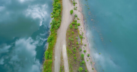 Aerial view of dirt road amidst lake
