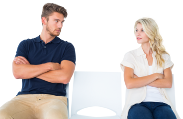 Young couple sitting in chairs not talking during argument