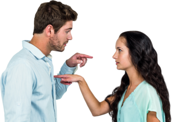 Side view of young couple pointing each other while arguing