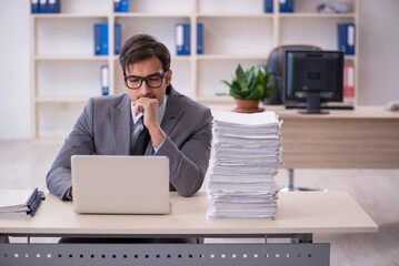 Young male employee and too much work in the office