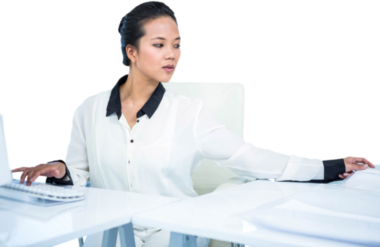 Smiling businesswoman typing on her computer - Powered by Adobe