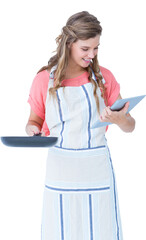 Happy hipster woman holding laptop and frying pan 