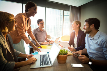 Happy colleagues discussing
